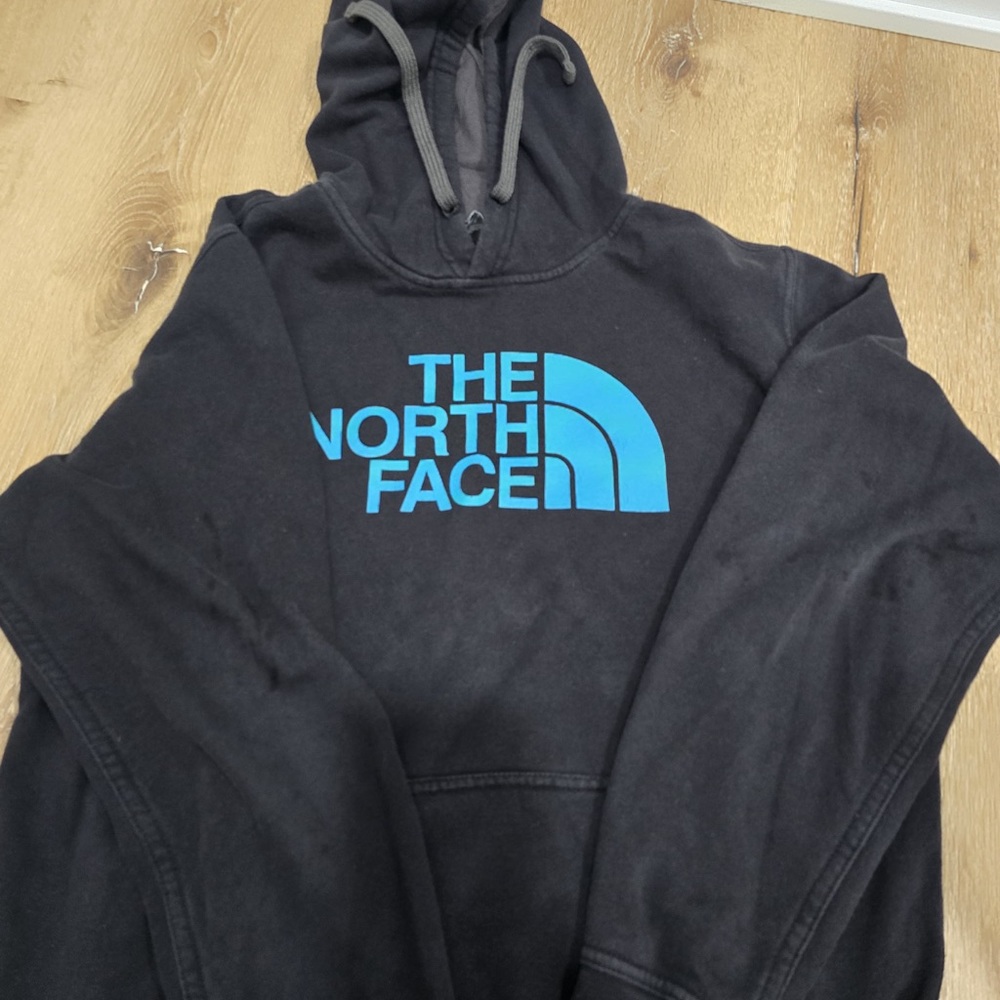 The North Face Black Hoodie with Vibrant Blue Logo